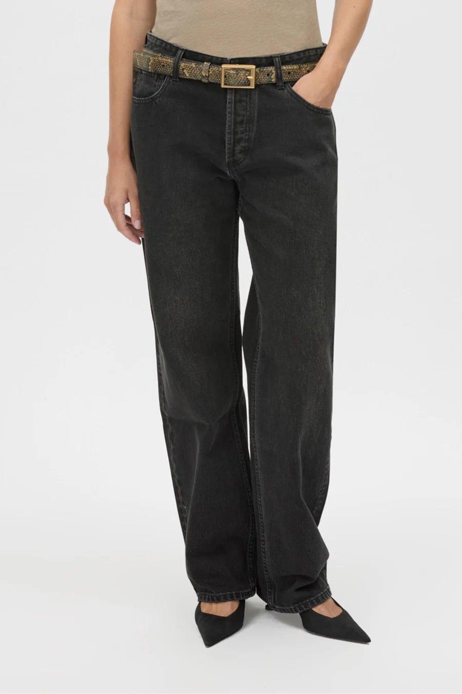 Person wearing black jeans with a belt on a white background