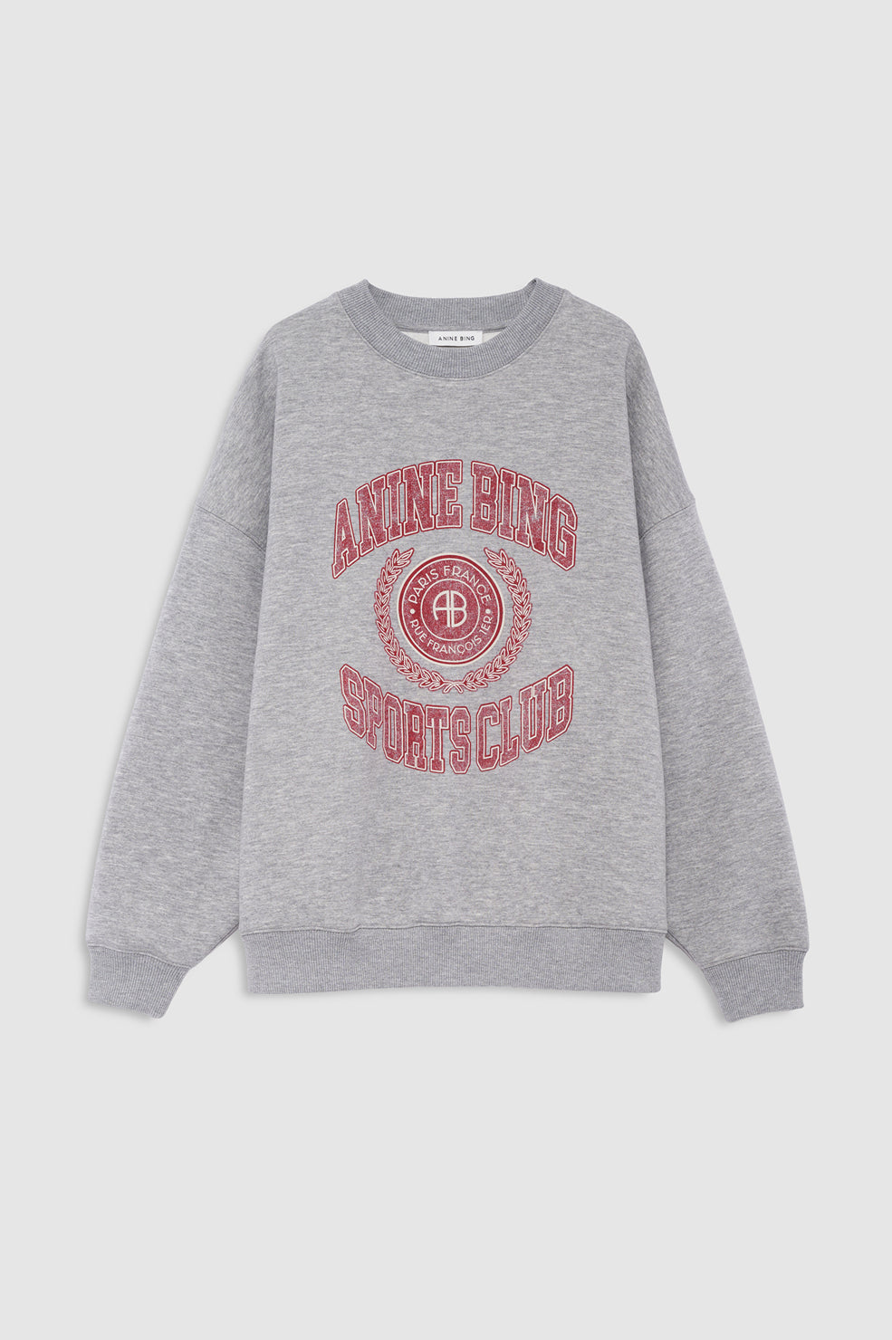 A heather gray crewneck sweatshirt with a red graphic print on the front reading 'ANINE BING SPORTS CLUB' around a circular logo, displayed on a light gray background.