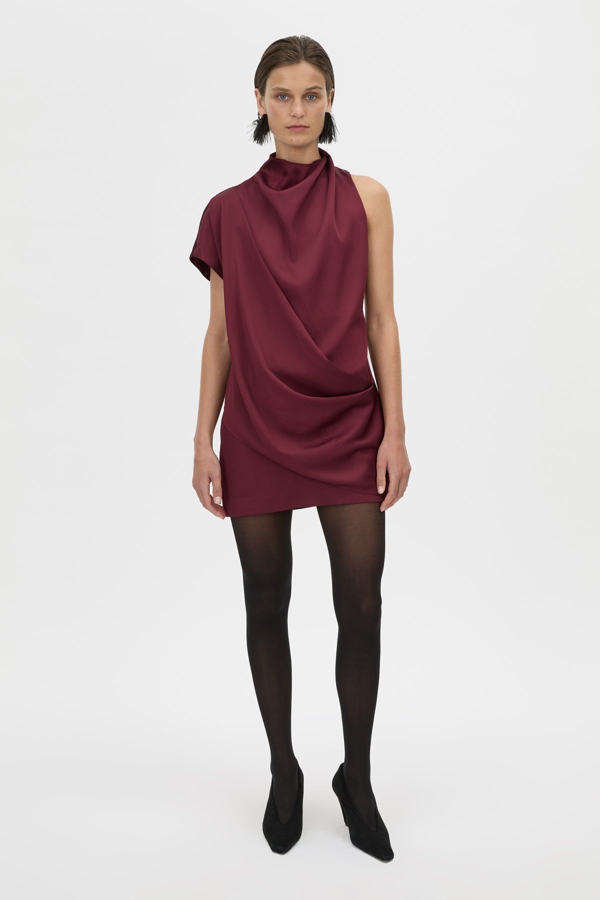 Woman wearing a burgundy dress on a white background