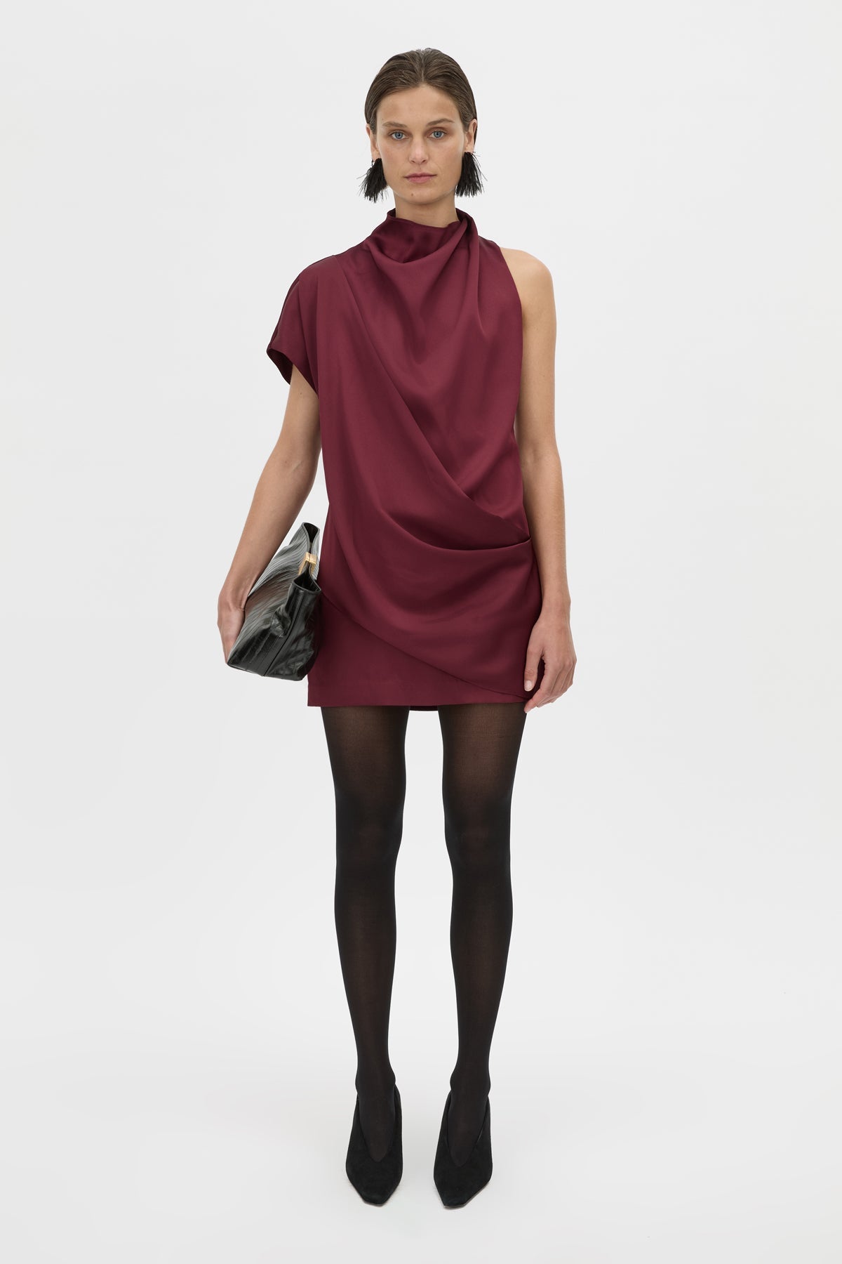 Woman wearing a burgundy dress on a white background