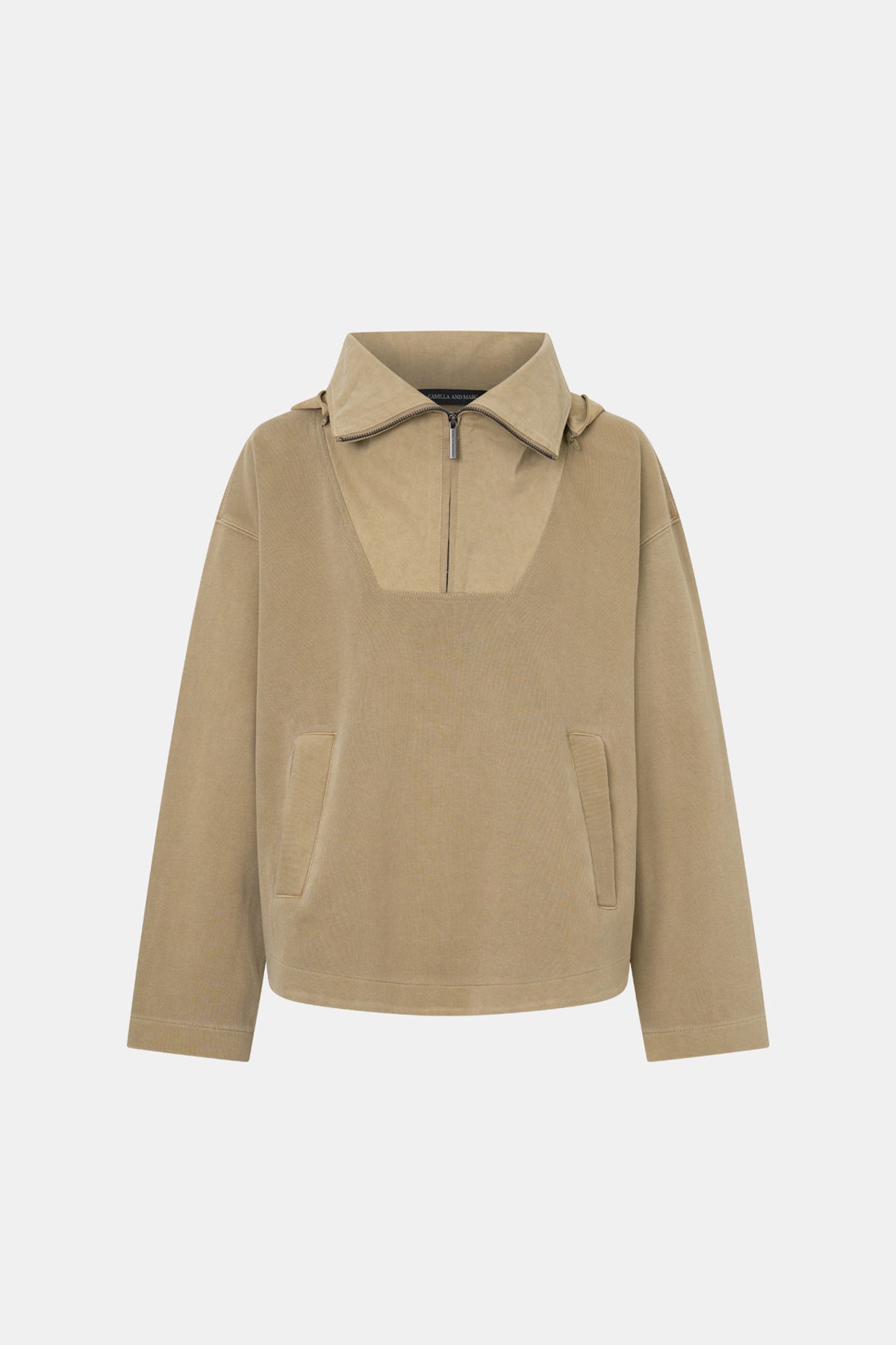 A beige pullover jacket with a mock neck, half-zip front, and two front patch pockets, shown on a plain light gray background.