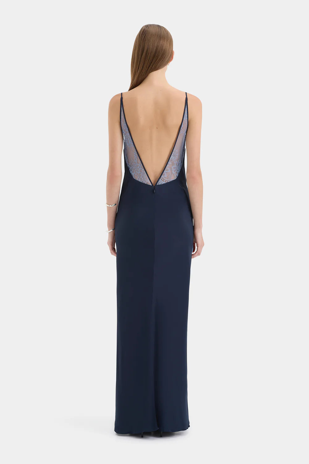 Navy blue evening gown with open back on a white background