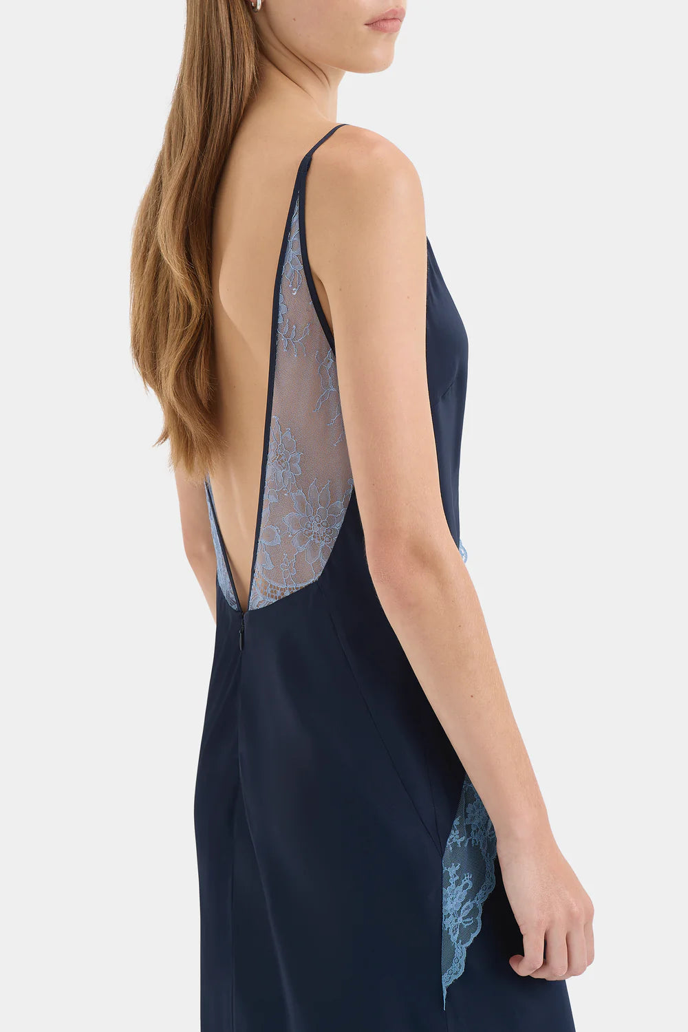 Navy blue slip dress with lace detailing on a white background