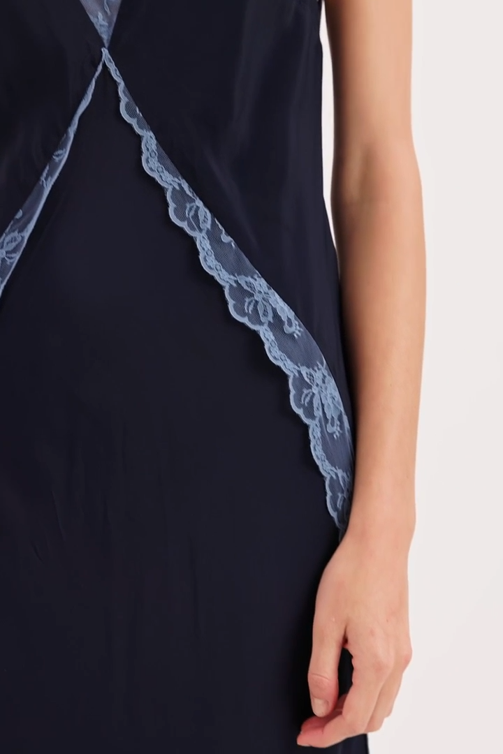 Navy blue dress with lace trim on a white background
