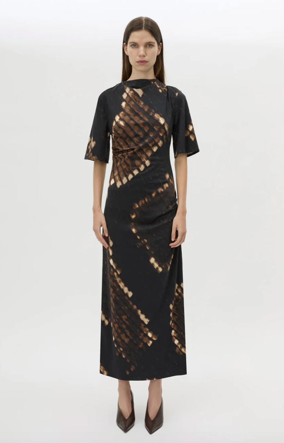 Woman wearing a black dress with a pattern on a white background