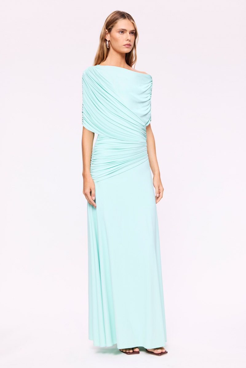 Woman wearing a light blue one-shoulder dress on a white background