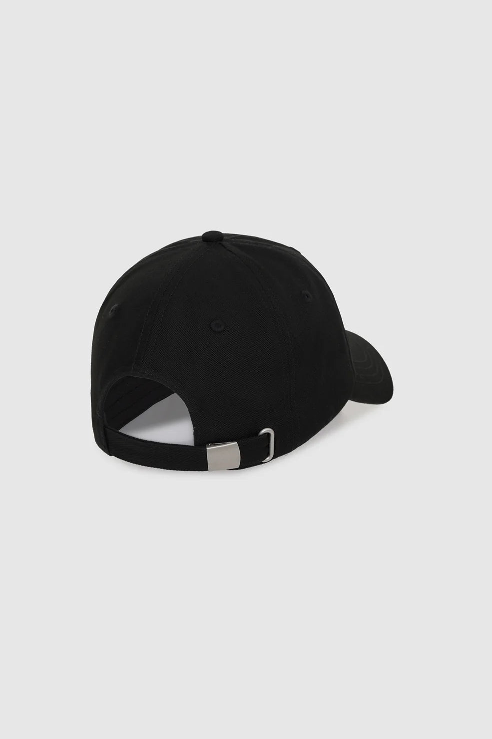 A black baseball cap shown from a rear three-quarter angle, featuring an adjustable black strap with a silver metal buckle, set against a solid light gray background.