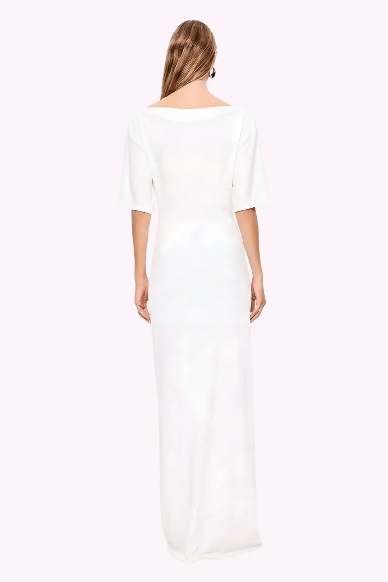 Woman wearing a white dress with a plain background