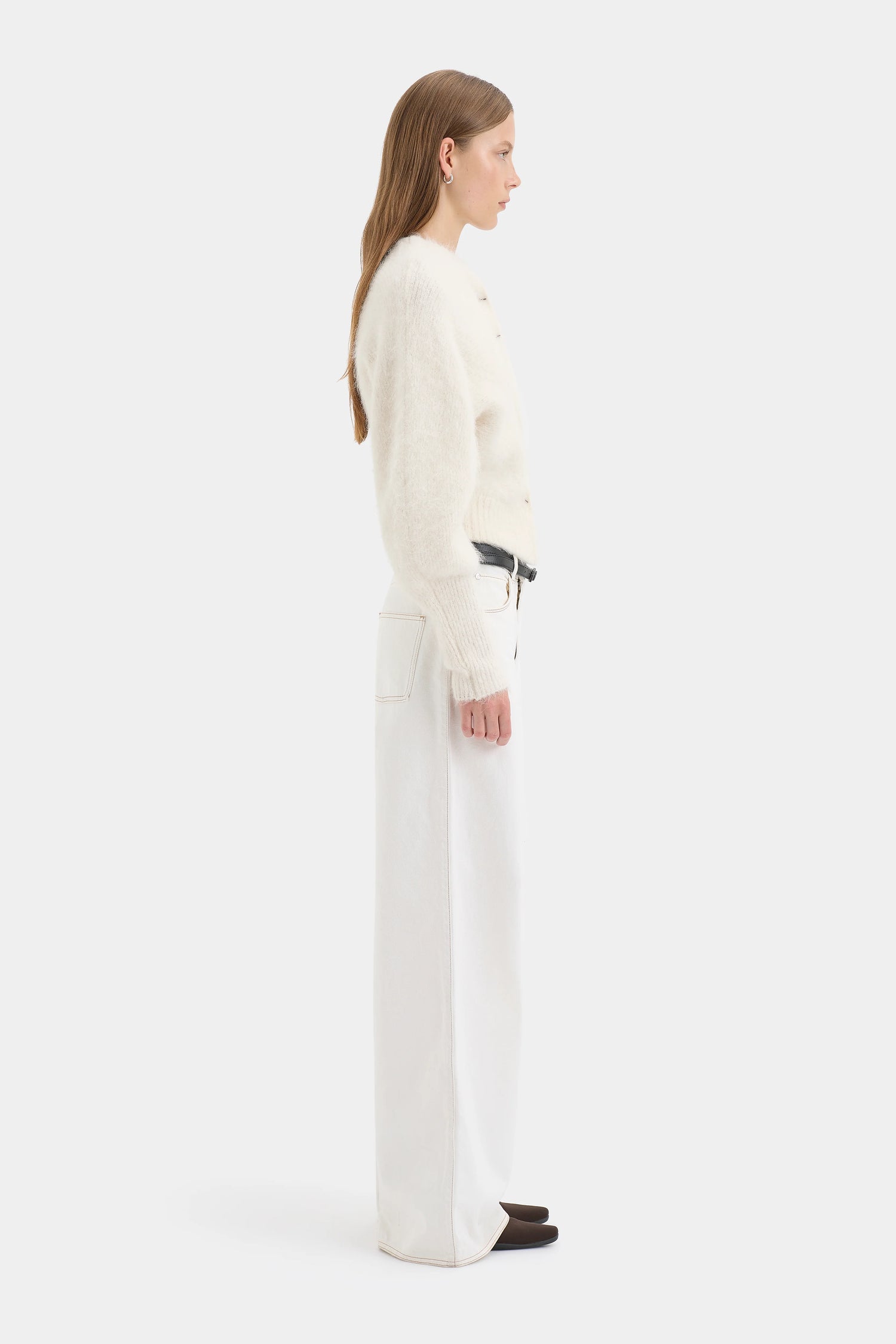 Person wearing a white Cardigan with a plain background