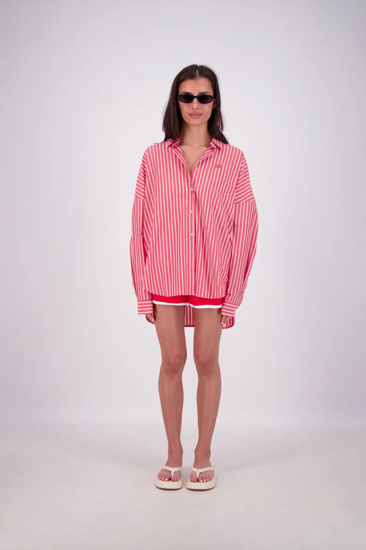 Woman wearing a red and white striped shirt on a white background
