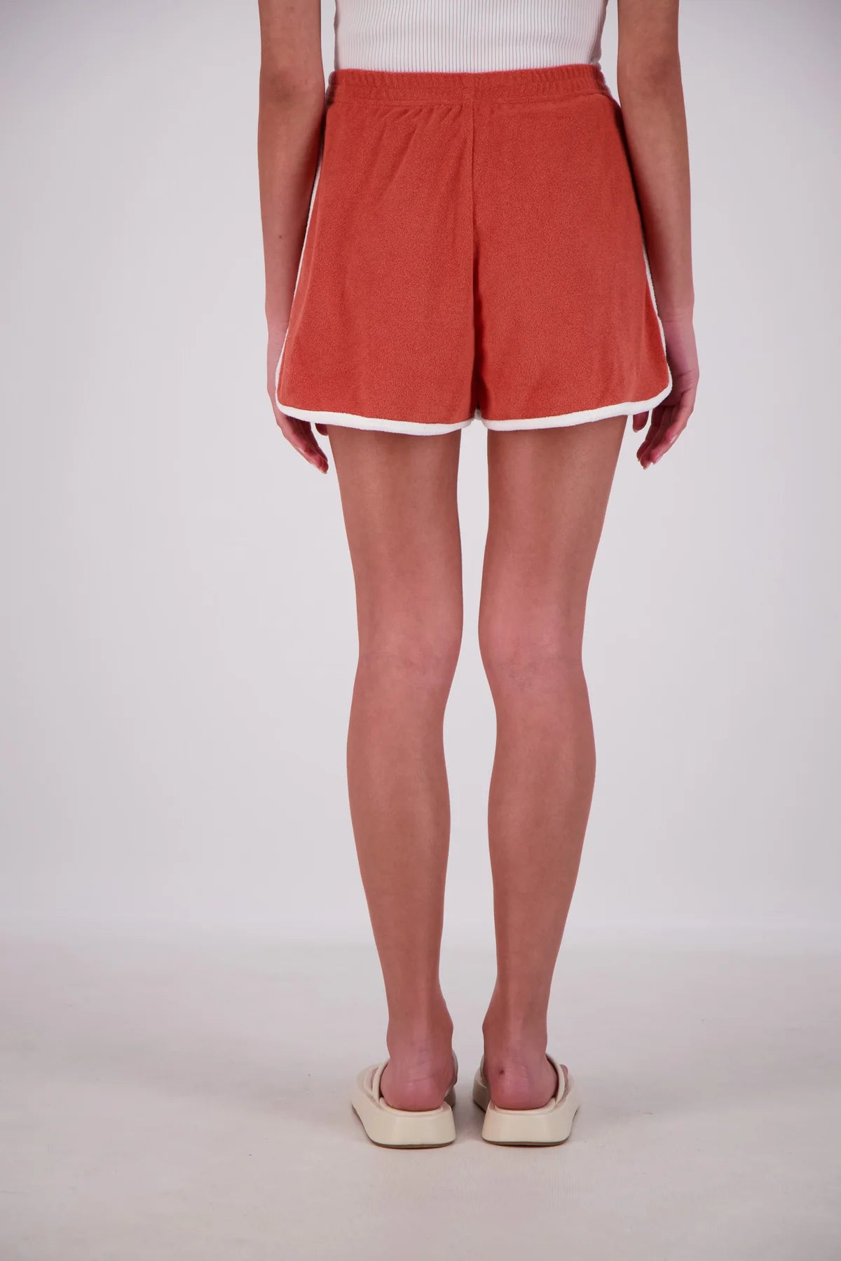 Person wearing red shorts on a white background