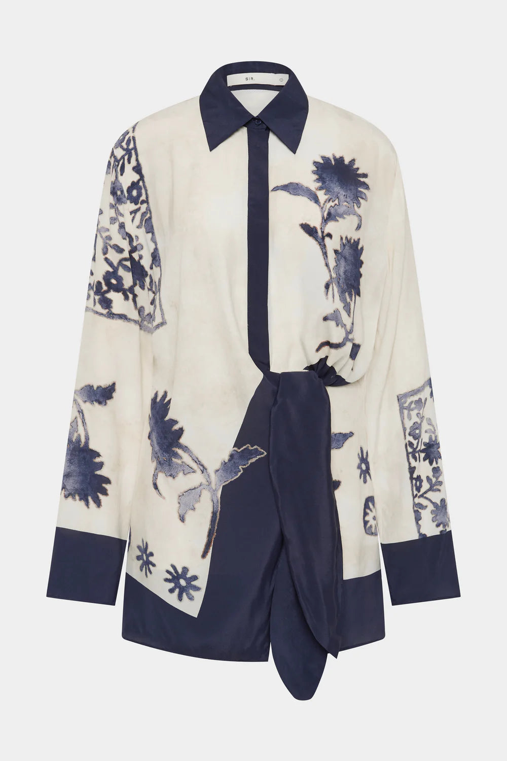 White shirt with blue floral patterns and a matching skirt on a white background