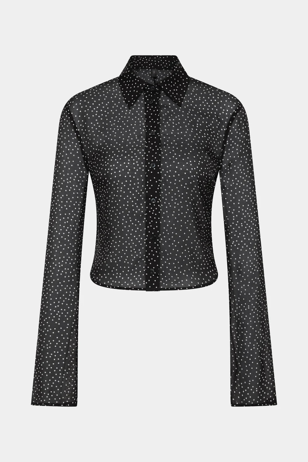 A black long-sleeve button-up blouse with a white micro-dot pattern, featuring a pointed collar and a tie-neck detail, shown against a light gray background.