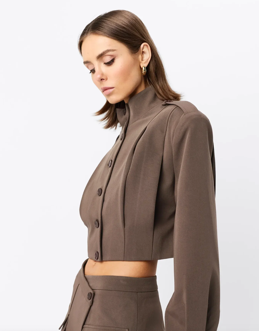 Woman wearing a brown outfit on a white background