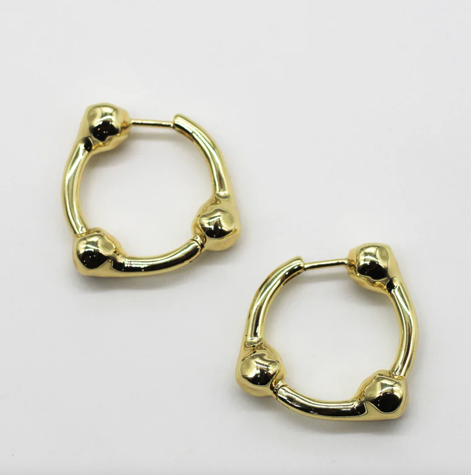 Gold hoop earrings on a white background
