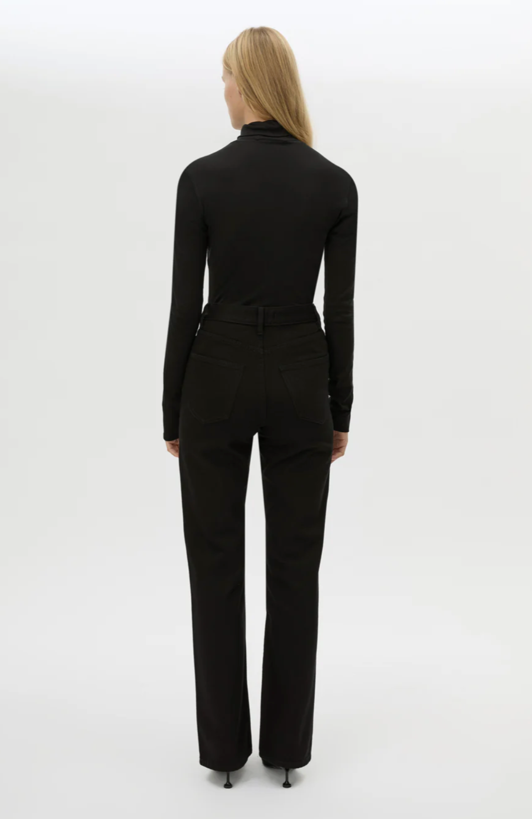 Person wearing a black suit on a white background