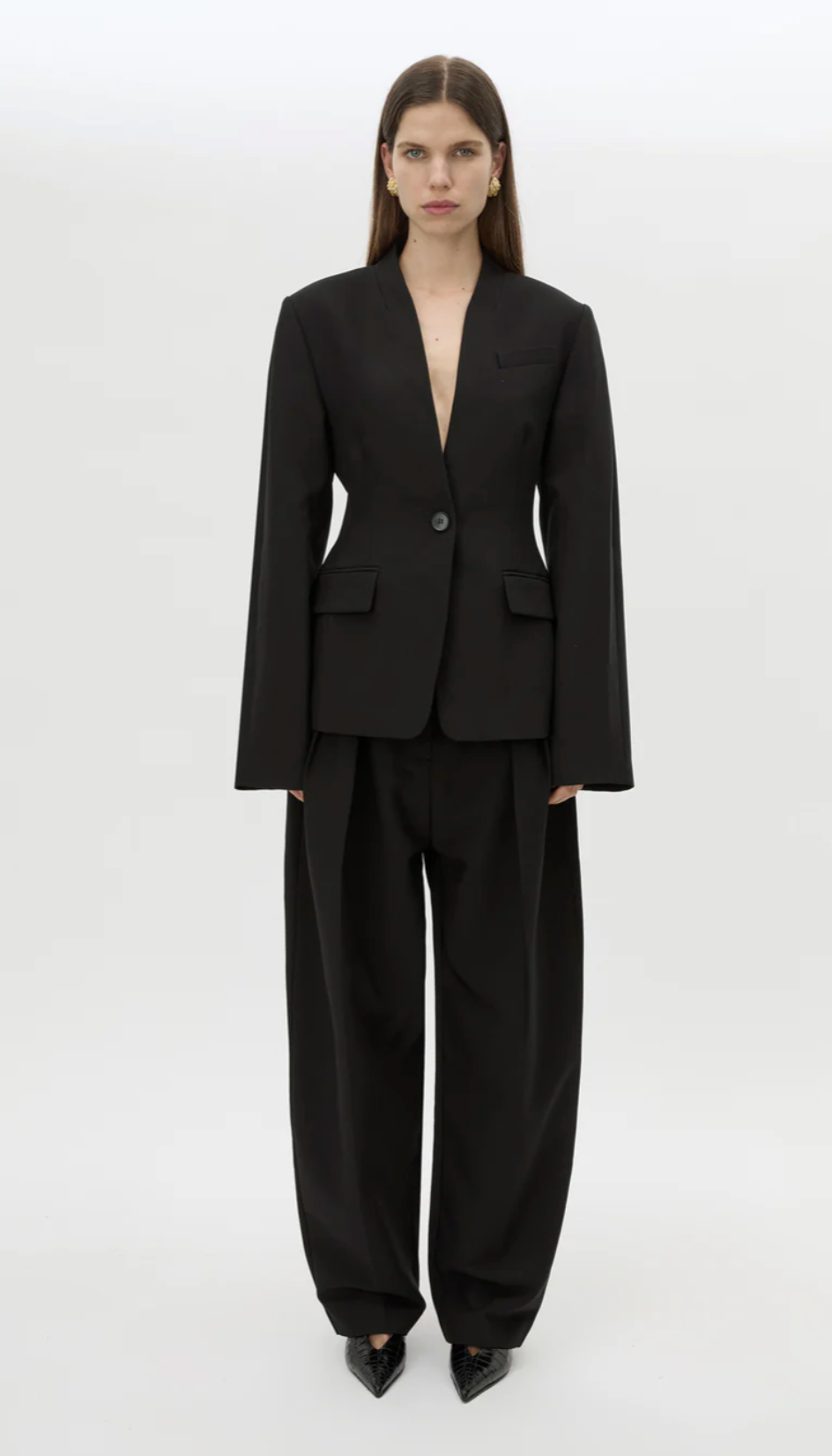 Person wearing a black suit on a white background