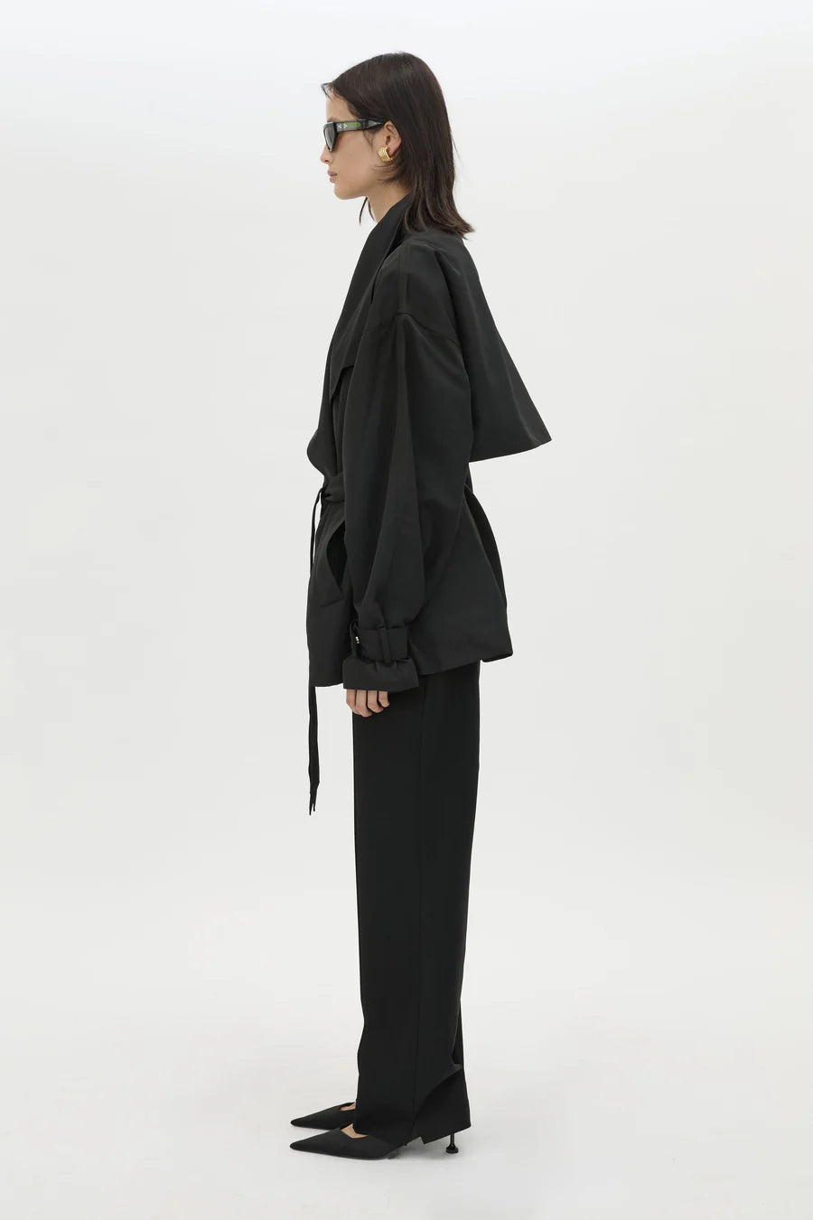 Person wearing a black outfit on a white background