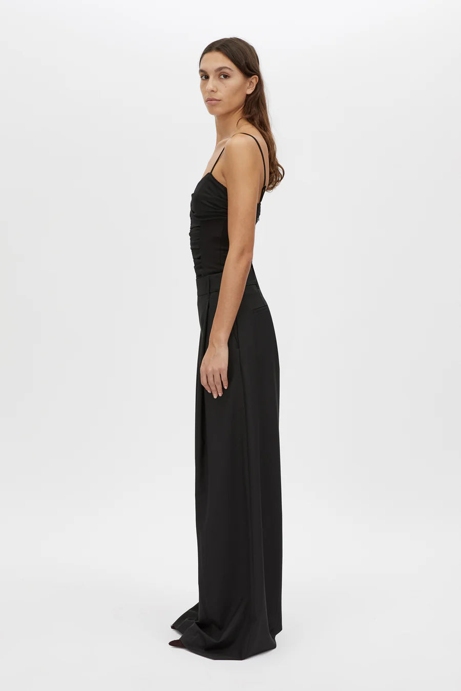 Woman wearing a black evening gown on a white background