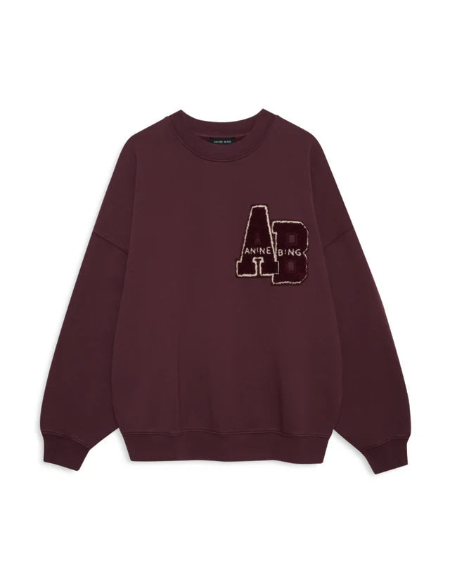 Maroon sweatshirt with a logo on a white background