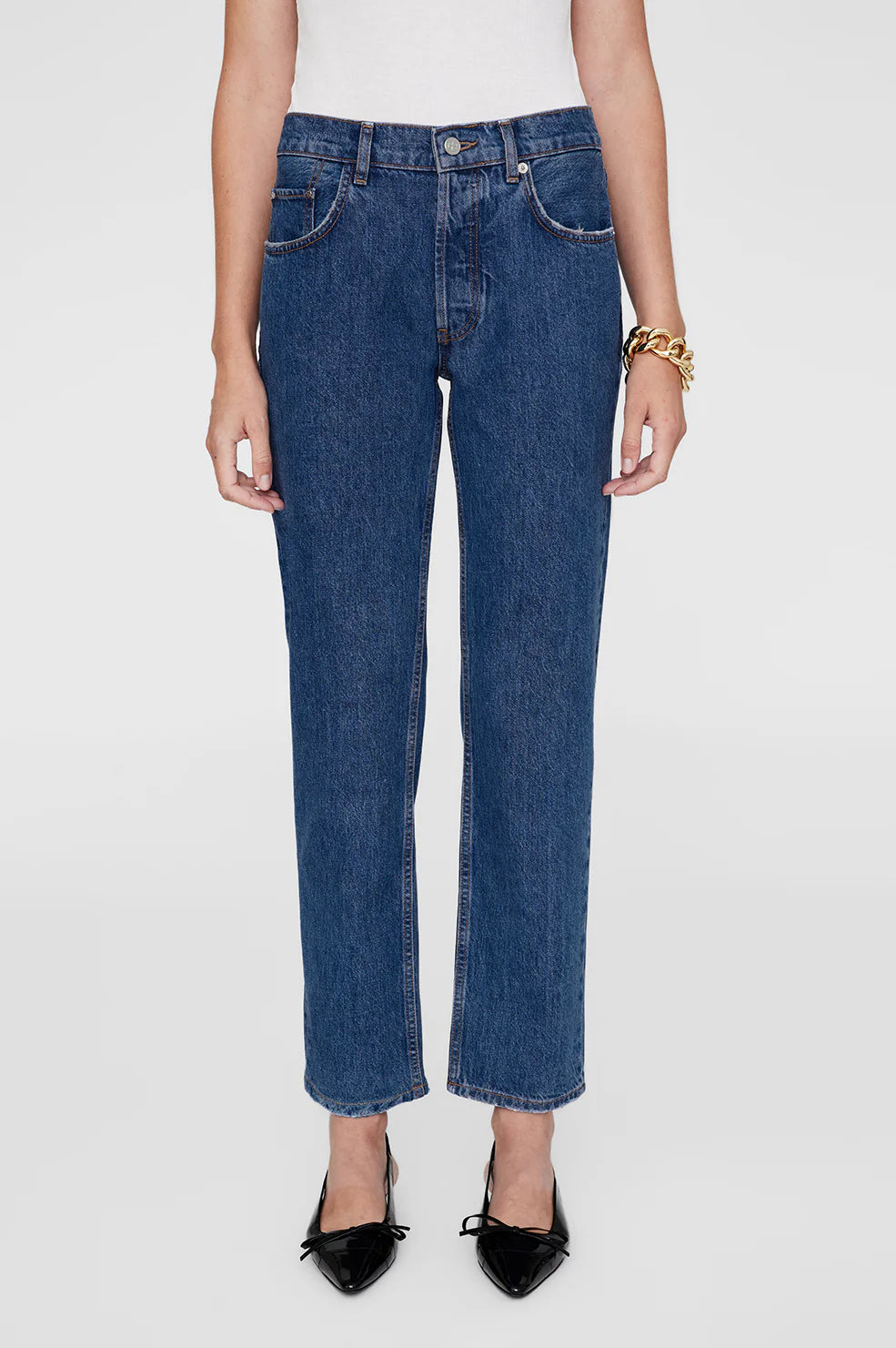 Person wearing blue jeans on a white background