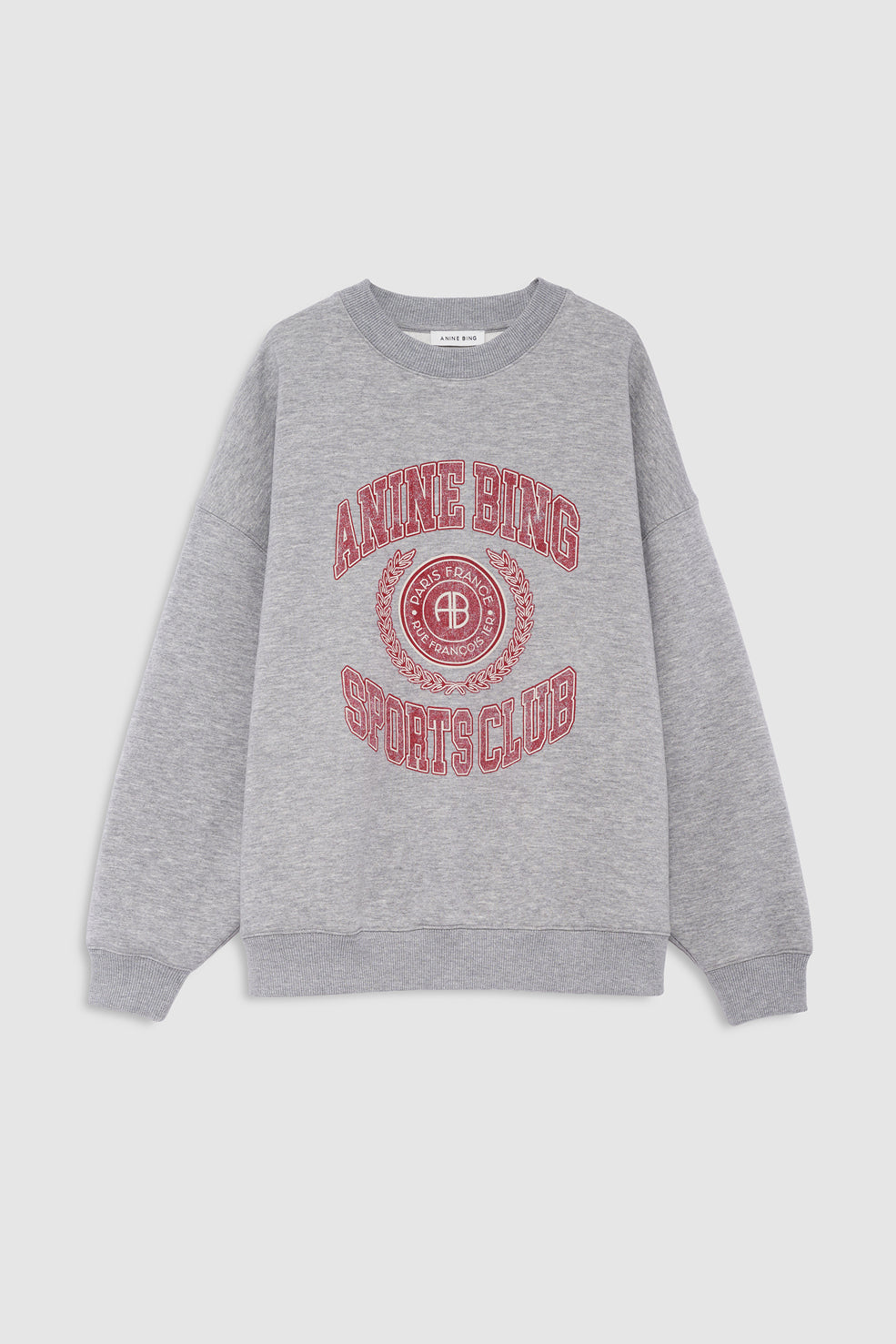 A heather gray crewneck sweatshirt featuring a red graphic print on the front that reads 'ANINE BING SPORTS CLUB' with a circular logo containing a 'B', displayed against a light gray background.