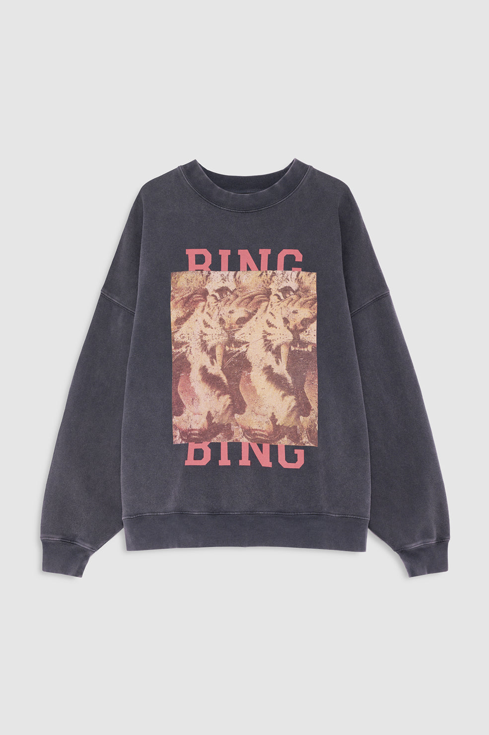 A dark gray washed crewneck sweatshirt featuring a large graphic print of a tiger on the front with the word 'RING' in pink above and below the graphic.