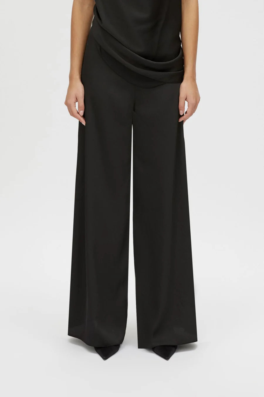 Black wide-leg pants worn by a person on a white background