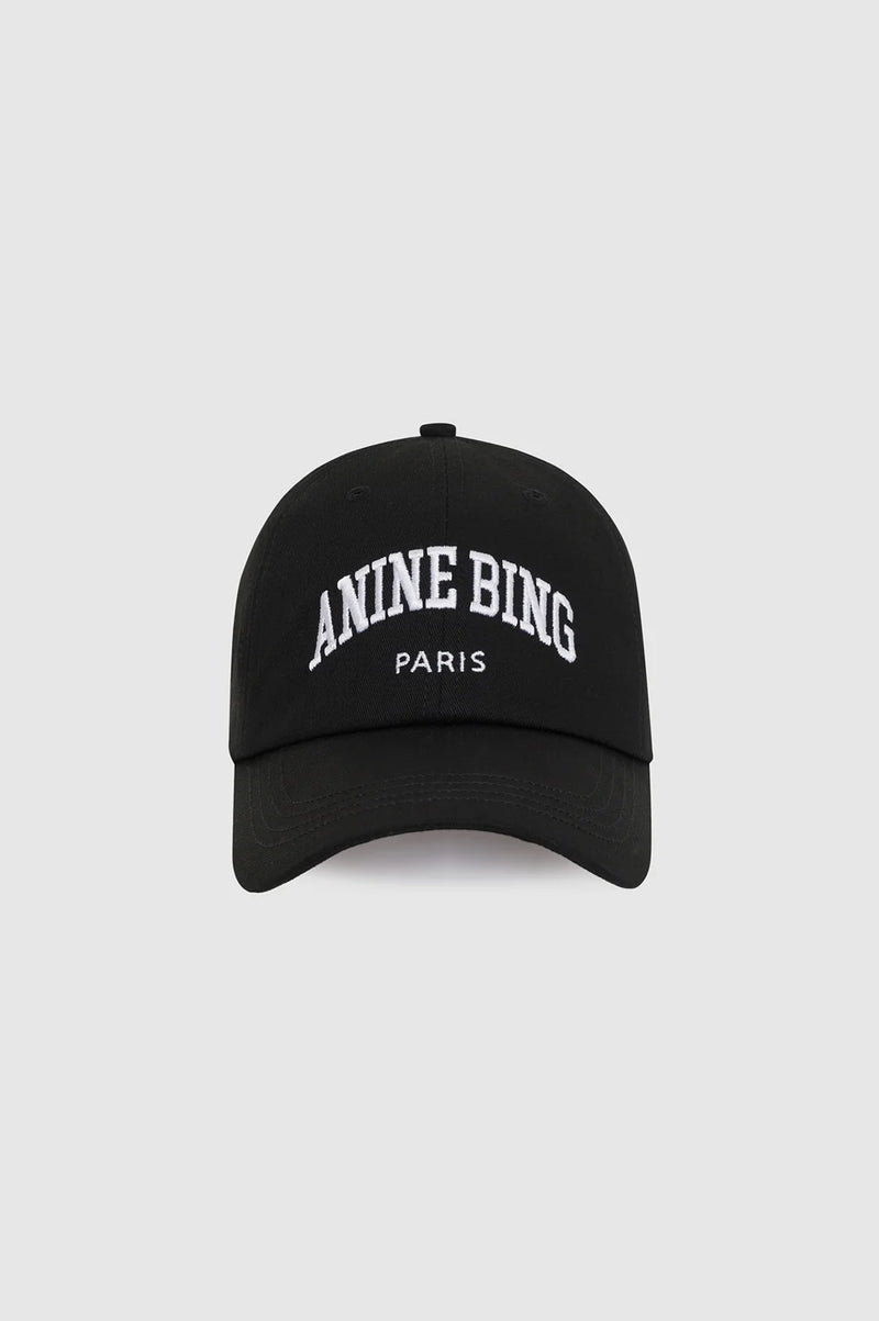 A black baseball cap with 'ANINE BING PARIS' embroidered in white on the front, set against a light gray background.