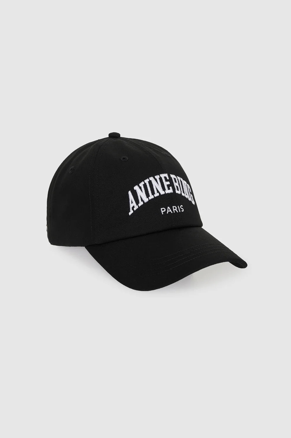 A black baseball cap with 'ANINE BORG PARIS' embroidered in white on the front, shown against a light gray background.
