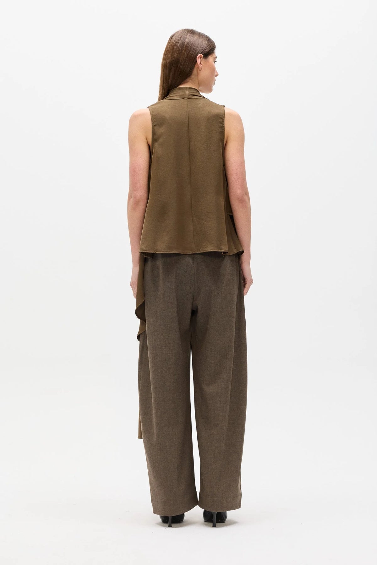 A model shown from the back wearing a sleeveless olive-brown vest and matching wide-leg trousers against a plain white studio background.
