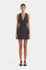 Woman wearing a Slate sleeveless dress  with lace detail on a white background