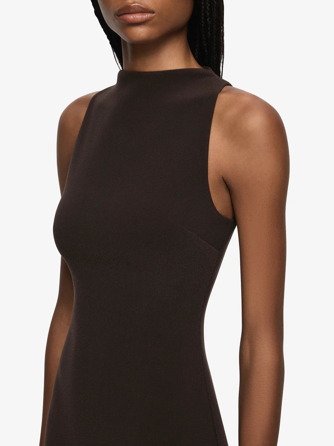 Black sleeveless dress worn by a model on a white background