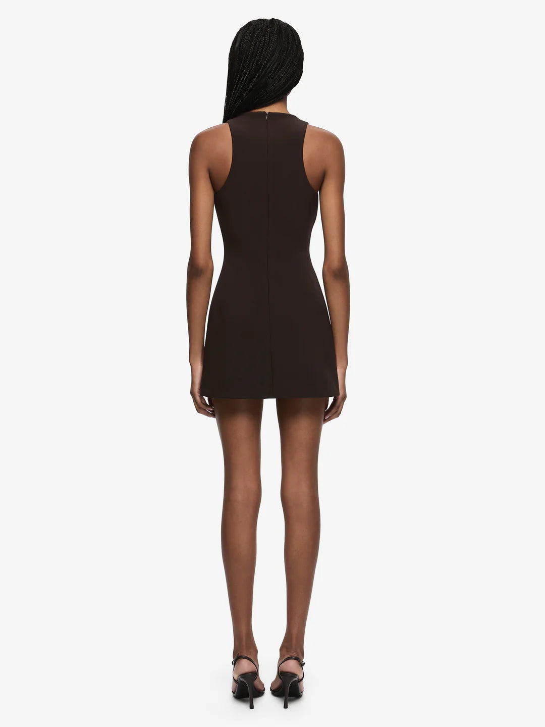 Woman wearing a black sleeveless dress on a white background