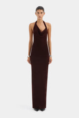 Woman wearing a brown halter neck dress on a white background