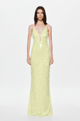 Woman in a lemon sequin dress on a white background