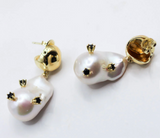 Pearl earrings with gold accents on a white background