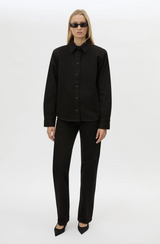 Person wearing a black outfit on a white background