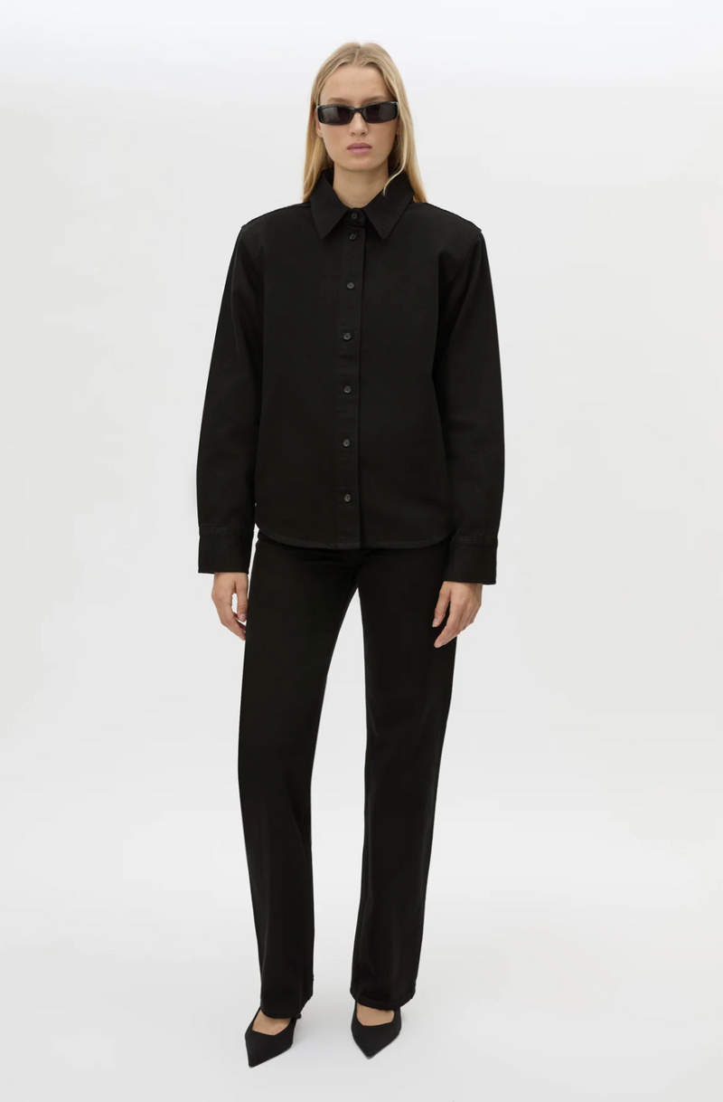 Person wearing a black outfit on a white background