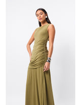 Woman standing in an olive dress for a special occasion.
Refined yet relaxed, the Sole Purpose Maxi Dress in Olive redefines everyday elegance. Designed in a soft stretch jersey fabrication, this sleeveless silhouette offers a round neckline and gathered detailing through the sides, sculpting the waist and hips for a flattering fit. The design falls to a gently flared maxi skirt, creating beautiful movement with every step. Body-lined for comfort, this dress is an effortless choice for both casual days and 
