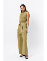 Woman standing in an olive top.
A sleek essential with a sculptural edge, the Sole Purpose Tank in Black brings modern ease to everyday dressing. Cut from a soft stretch jersey fabrication, this sleeveless style features gathered detailing through the sides and bodice, creating a flattering, body-skimming silhouette. Designed with a high round neckline and half lining through the body, it delivers both comfort and structure. Pair back with tailoring or relaxed separates for effortless sophistication.